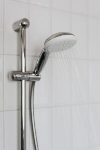 shower head providing cold water because property needs Houston commercial plumbing company to fix water heaters